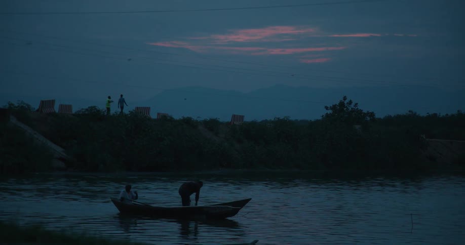 Boat floating on a body of water at night