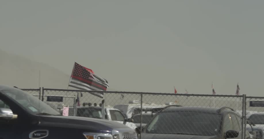 A flag attached to a buggy waves in the wind