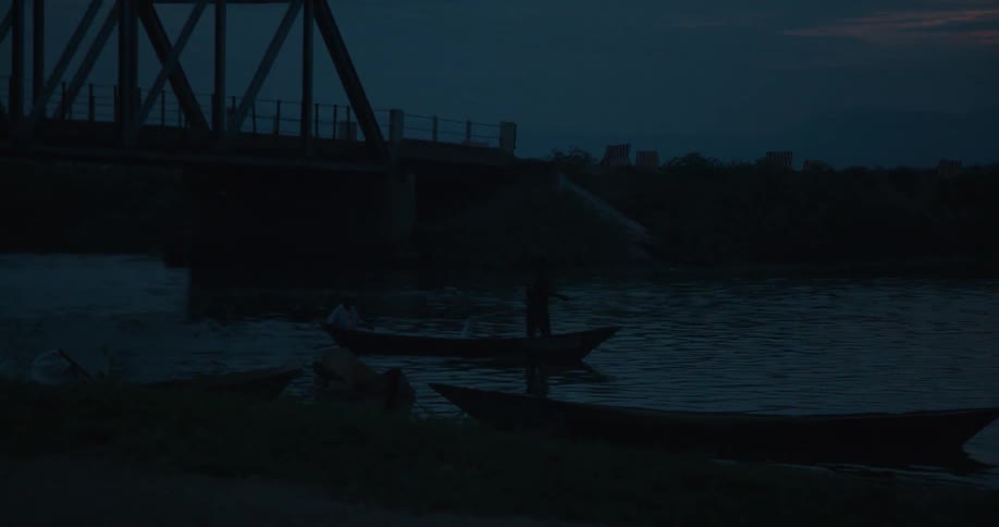 Boat floating on a body of water at night