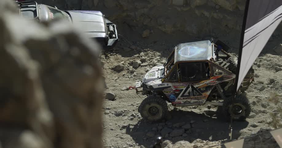 Race car driving on rocky terrain
