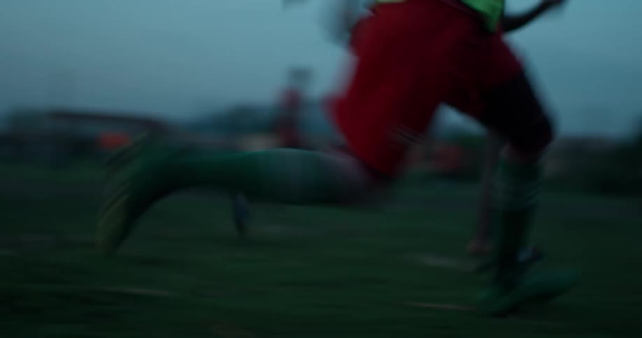 A group of young boys play soccer
