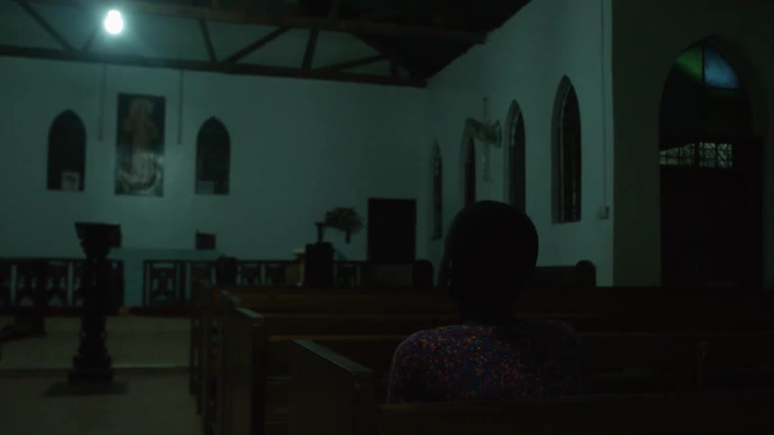 One person is sitting in an empty church