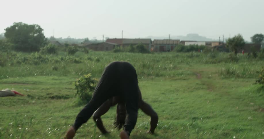 A man is still standing on a field