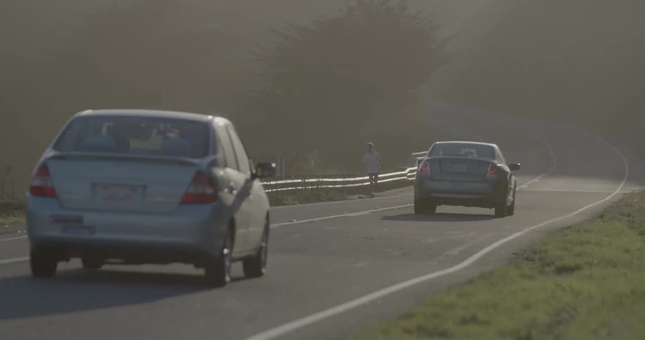 Cars are moving on the road on a bright sunny day