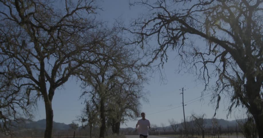 A man jogs down a street