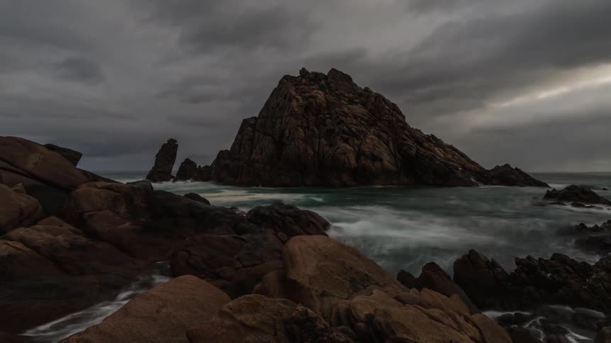 A timelapse of a rocky coast with moody skies