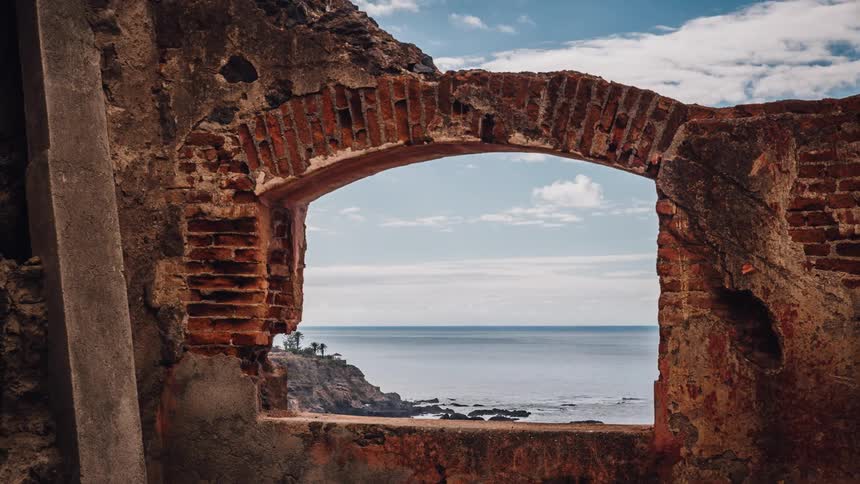 A broken brick building near the ocean