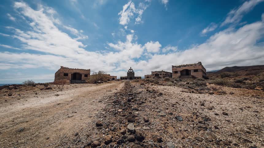 Decrepit buildings on a gravelly road