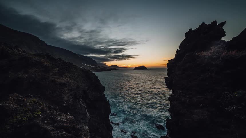 Waves crash against the rocky shore