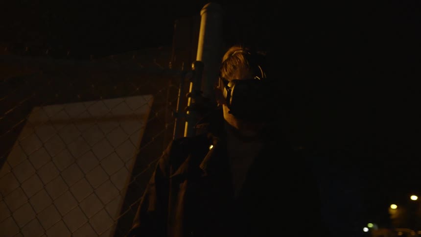 A girl is standing in an alley using a vr device