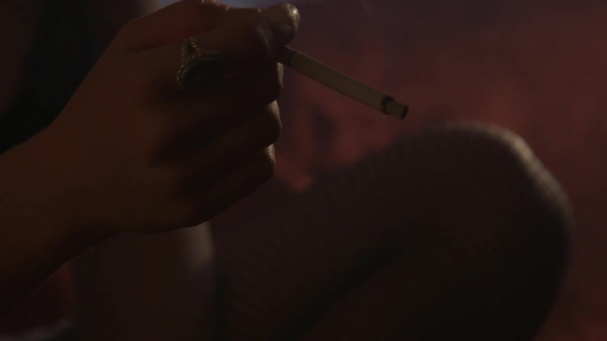 Someone is sitting and smoking