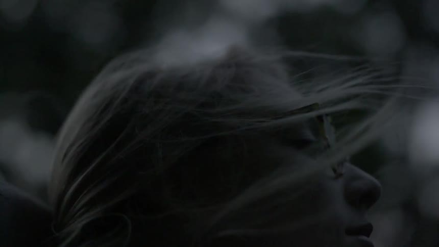 Woman's hair blows gently around her face