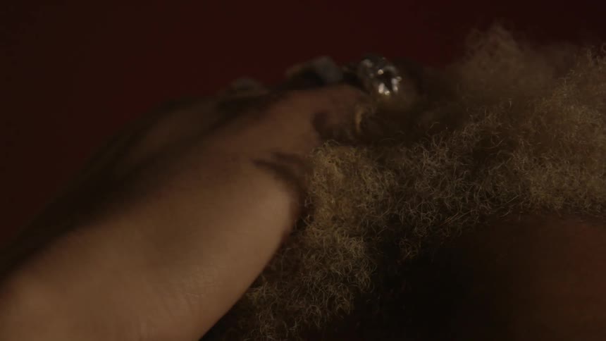 Someone is running their fingers through someone's hair