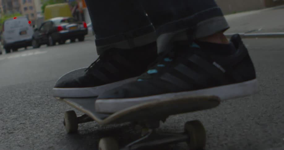 Someone is riding their skateboard through a city street