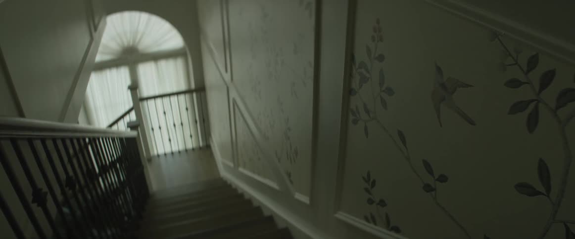 Wallpaper hangs on the staircase wall