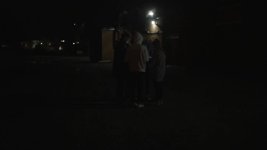 A group of young adults in a parking lot