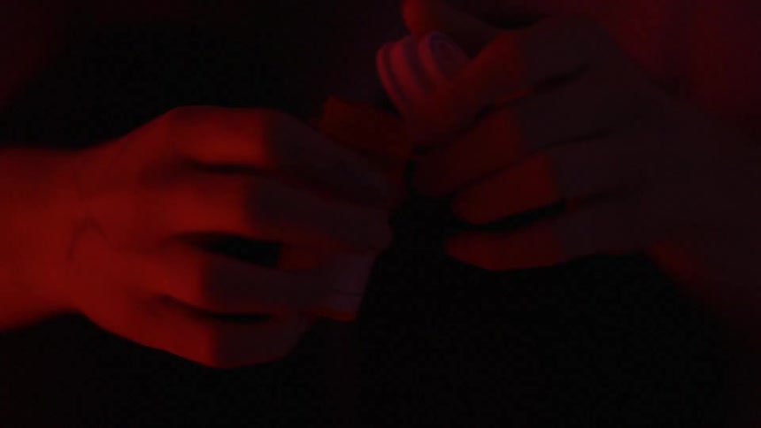 Someone is holding and opening a pill bottle
