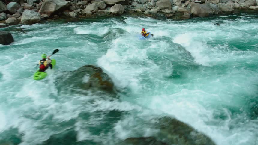 Kayaks move quickly through the rough water