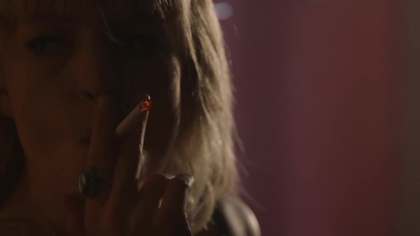 A person smoking in a red painted room