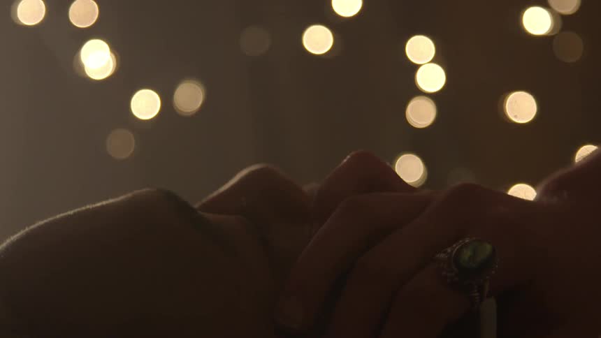 A woman is touching a man's face