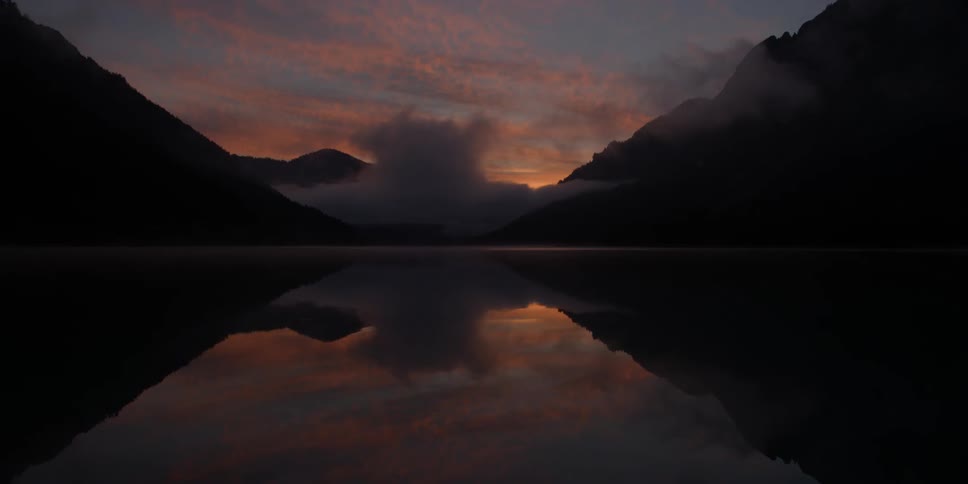 Clouds hang low above a lake