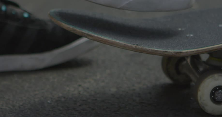 A foot is propelling a skateboard forward