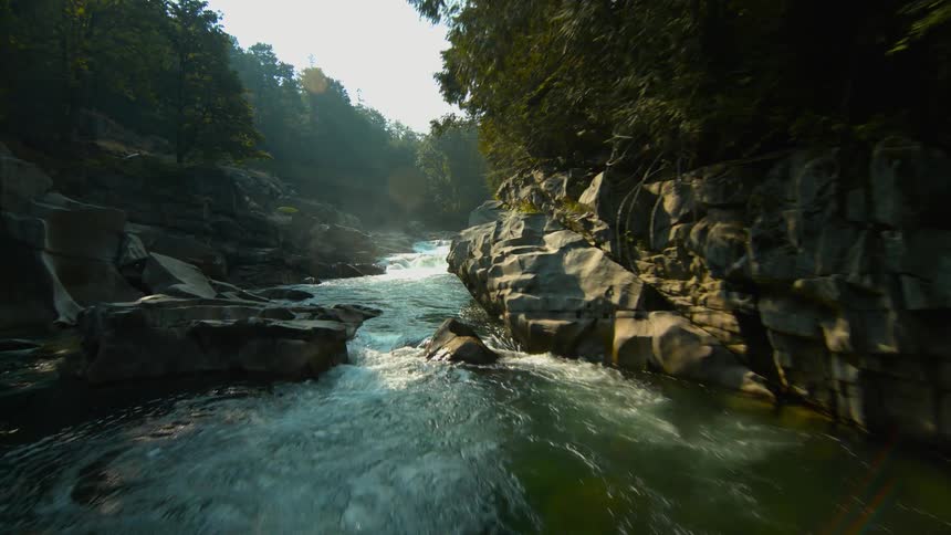 A river is flowing over boulders in a gorge