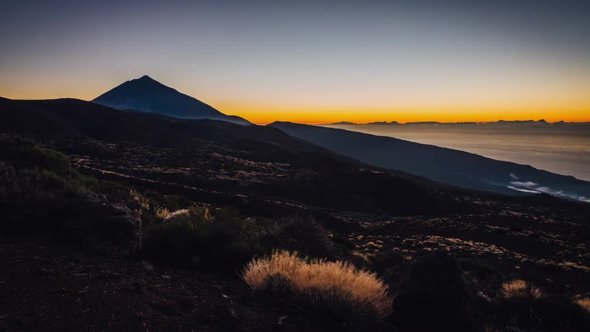 The sunset behind misty mountains