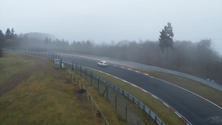 A vehicle travels down a road driving course
