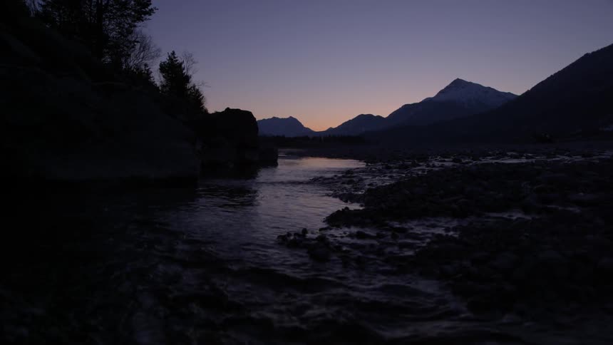 A stream is being filmed at dusk