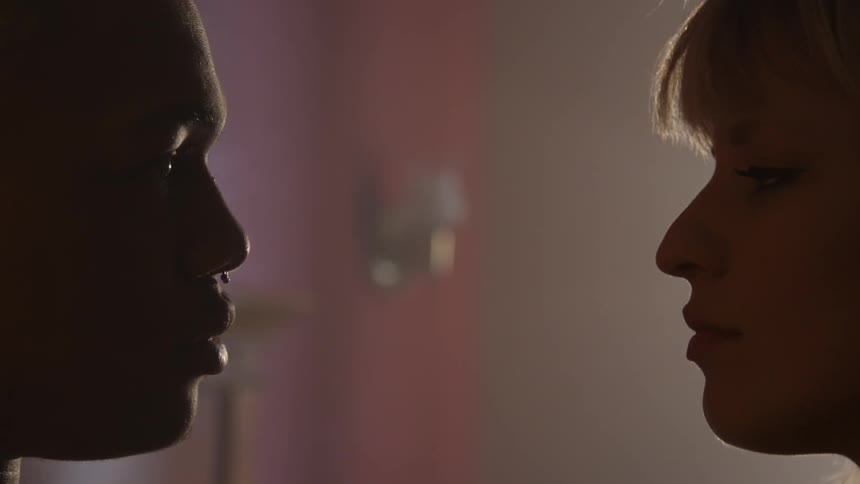 A man and woman are staring into each other's eyes