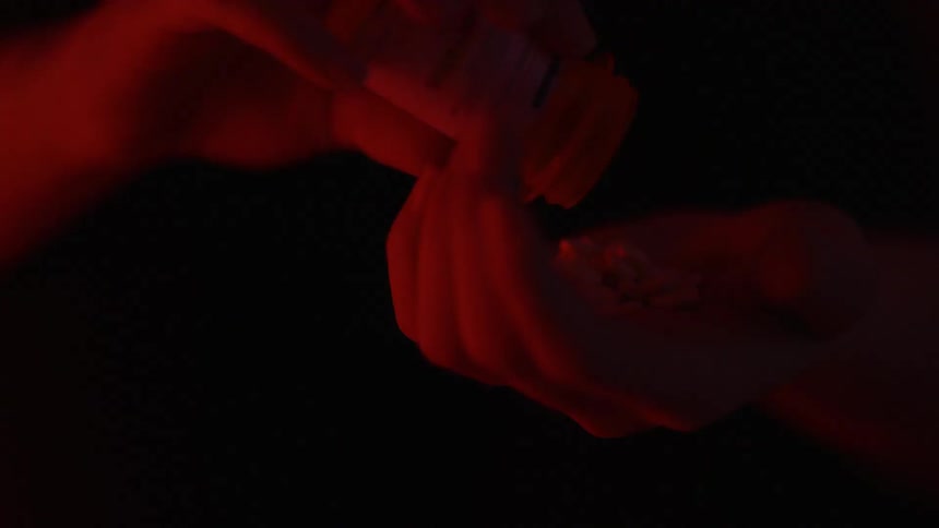 Someone is pouring pills out in their hands