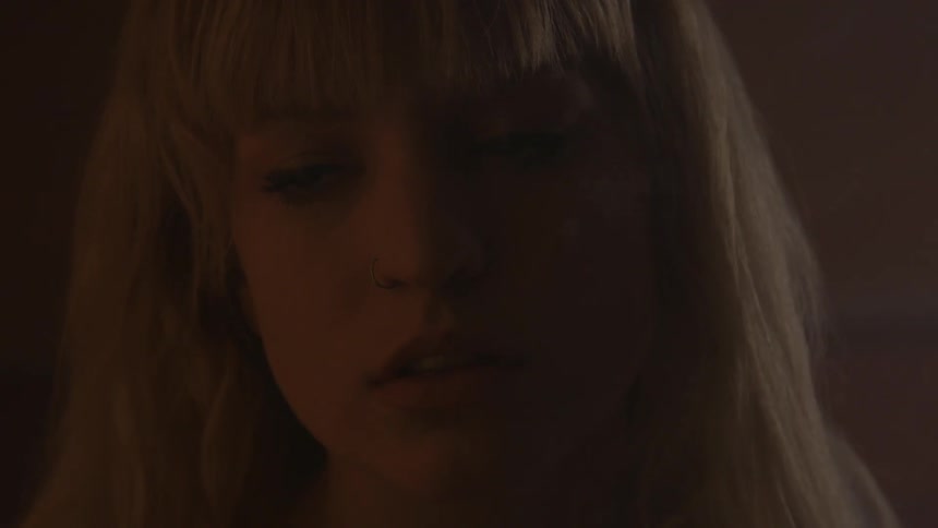 A blonde woman is smoking