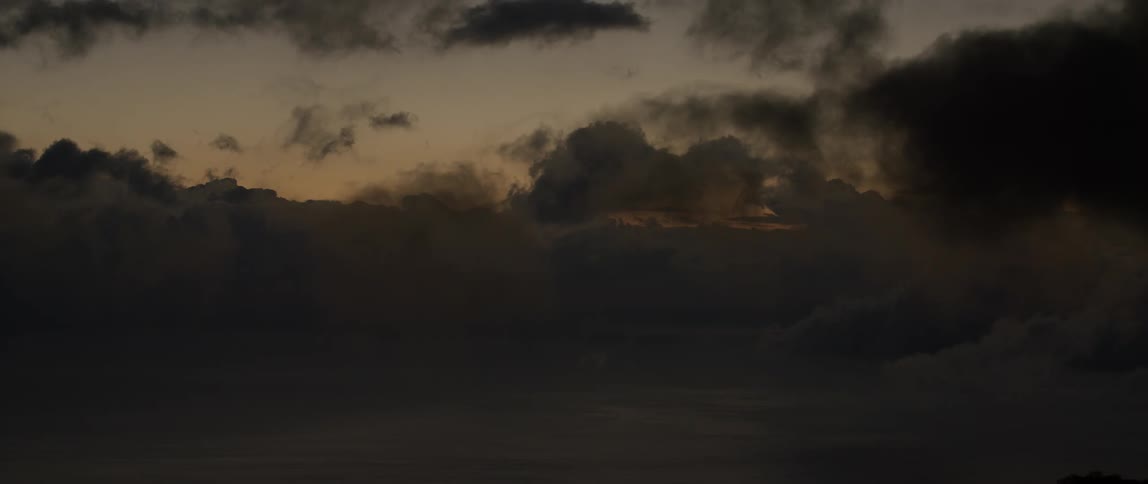 Clouds and fog move in the sky at sunset