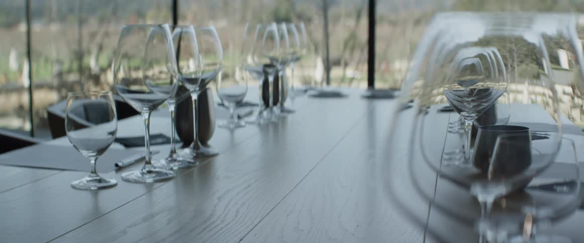 Glasses and notepads sit waiting on a table