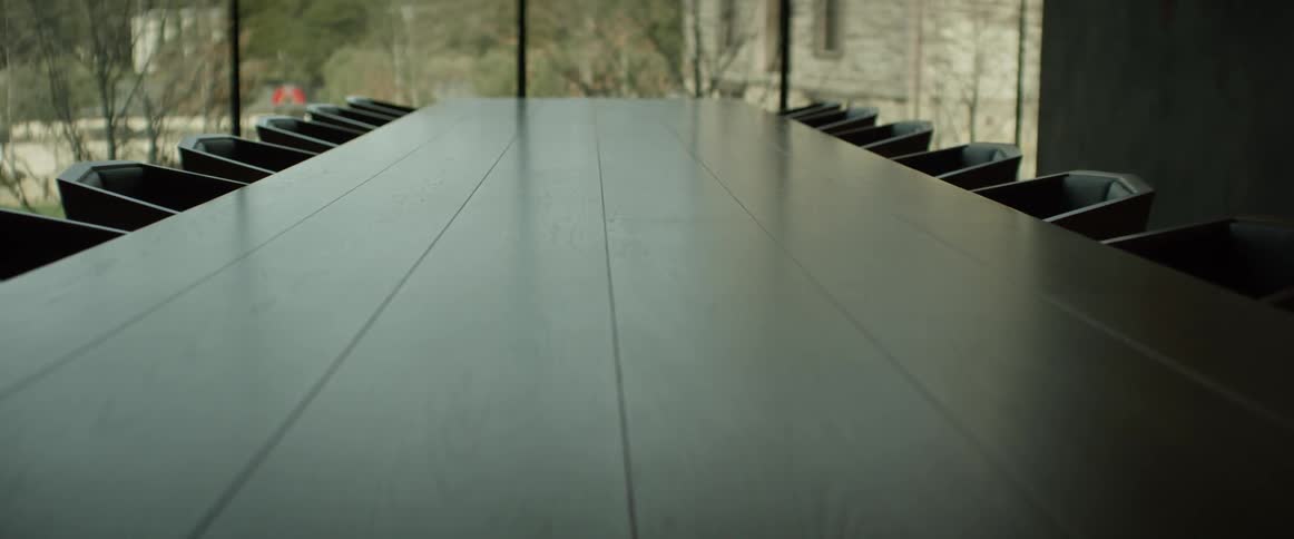 Chairs lined up next to a shiny table