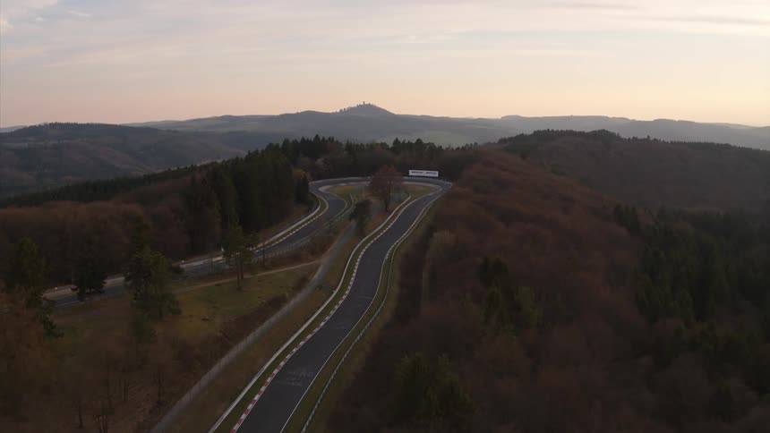 A sharply curved road through a forest