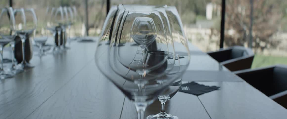 A table lined with wine glasses