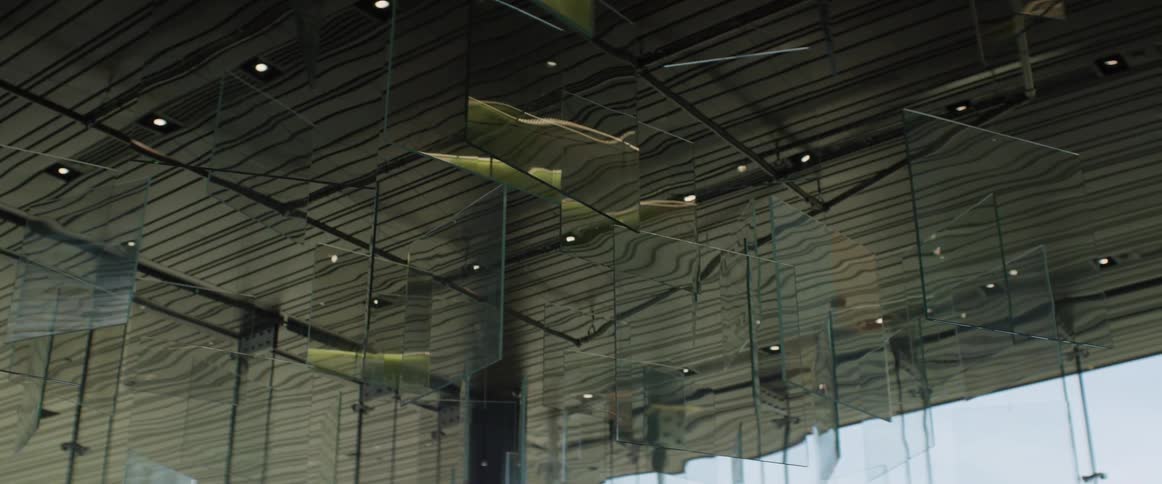 An art installation of glass panels reflects its surroundings