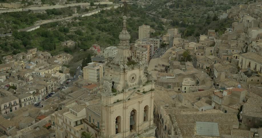 A church tower stands tall in a city