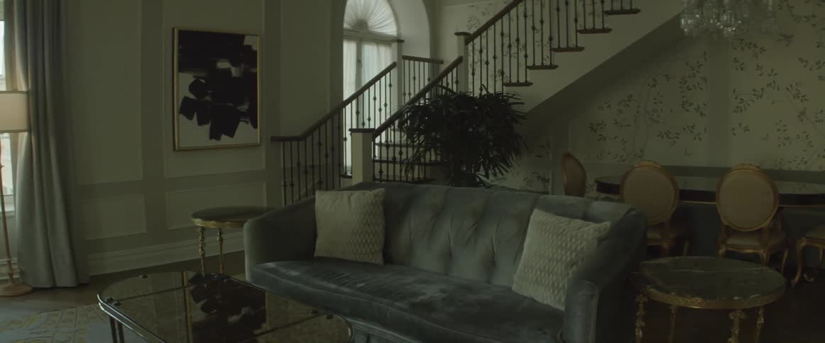 Someone is creeping down a staircase in a house