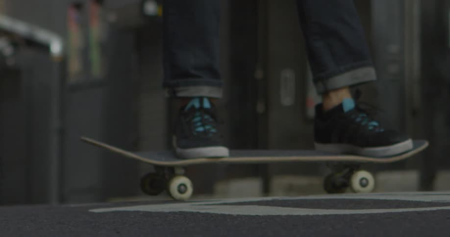 A skateboarder turns back and forth