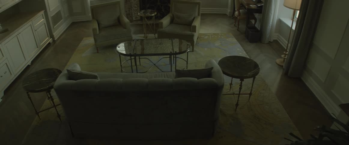 An empty house is being filmed from the stairs