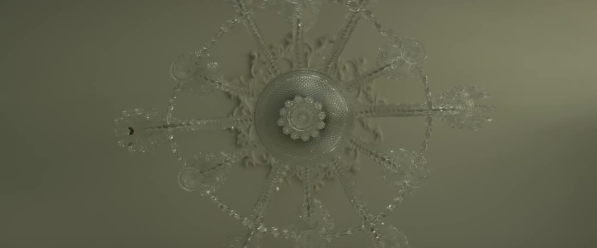 A crystal chandelier on a white ceiling