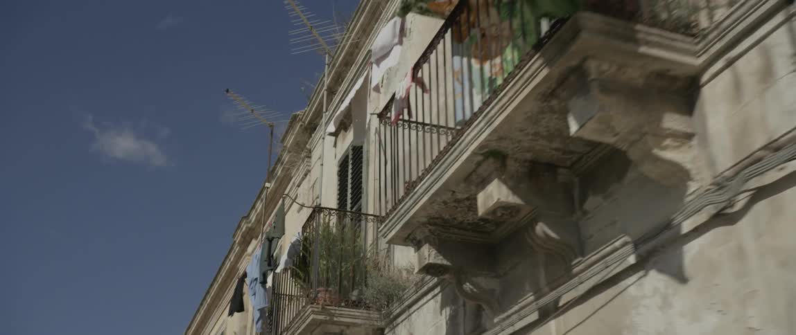Balconies with clothing hanging off of them