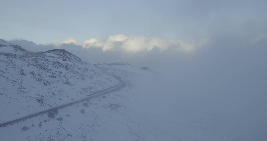 Haze lifts above the snowy mountains