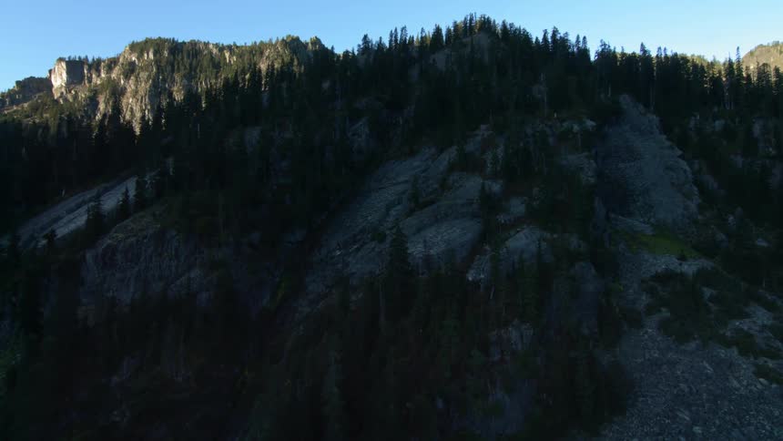 A rocky hill covered with scattered trees