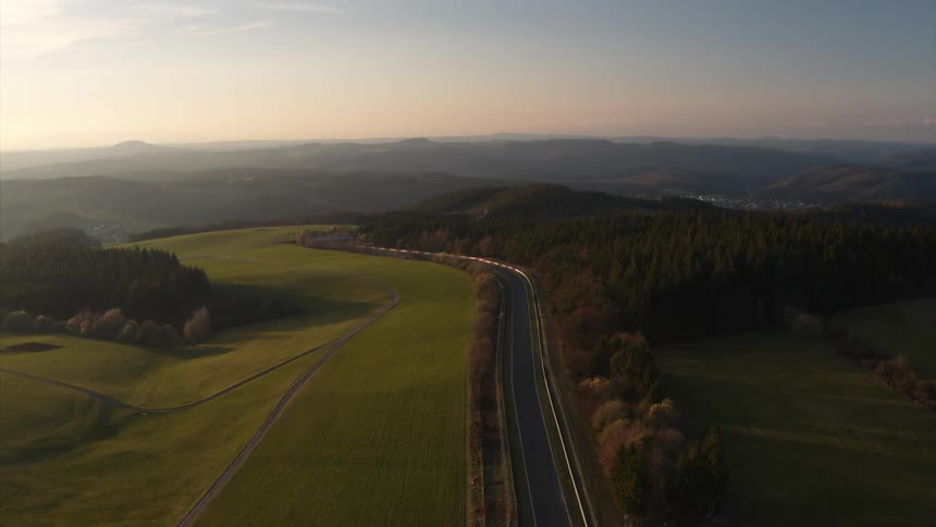A winding road driving track is set up in the hills