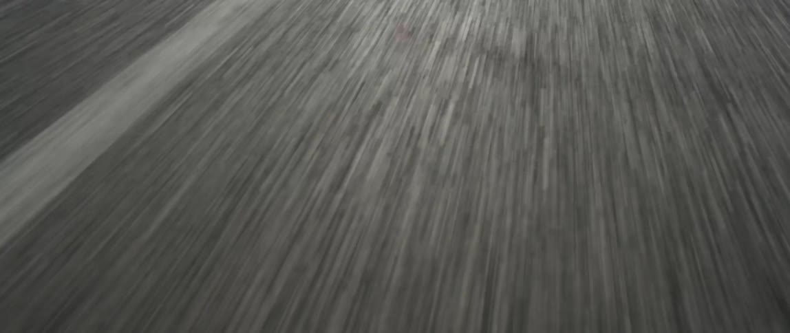 A white stripe divides an asphalt roadway