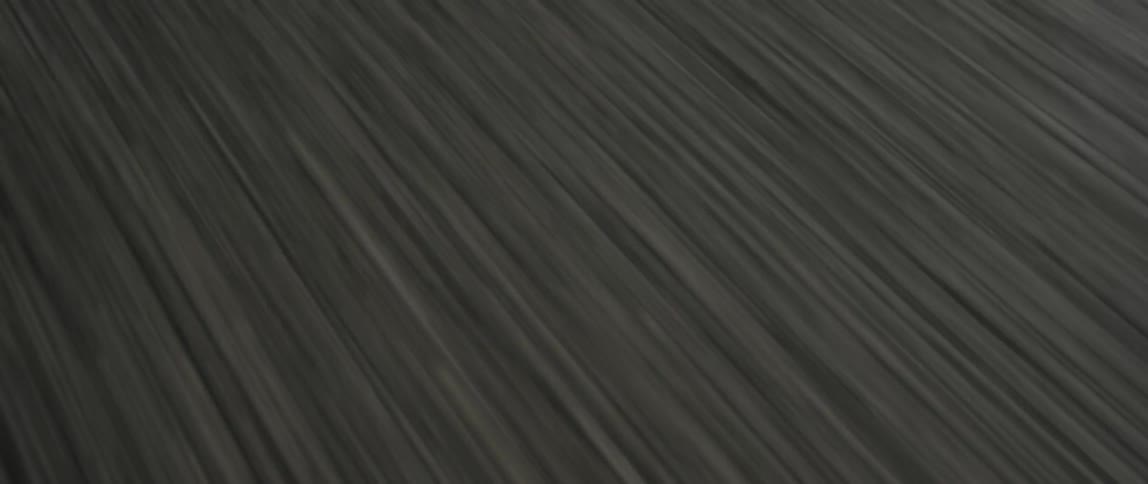 White road markers on the asphalt are passed by at speed